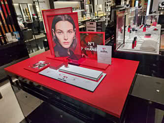 An advertising display for Chanel inside a shopping centre, front view to the right a little