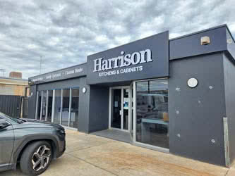Front right outside view of a business building, belonging to 'Harrison Kitchens & Cabinets', overcast day