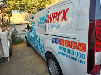 Hyundai work van belonging to Poolwerx, side view from behind, showing business graphics wrap