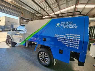 A Ford Ranger work vehicle with metal canopy