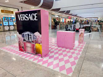 A sizeable advertising display for perfume inside a shopping centre