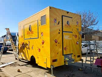 Food trailer, newly wrapped with business graphics, belonging to Moi An Viet Street Food, view from behind/side